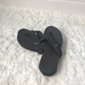Brown Nike flip flops